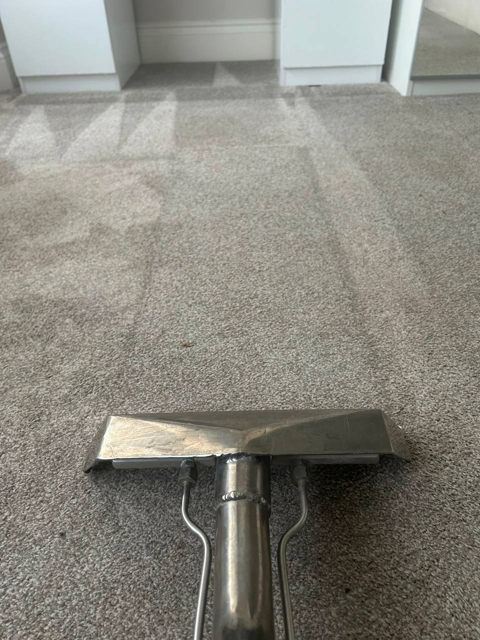 Professional extraction wand cleaning a carpet