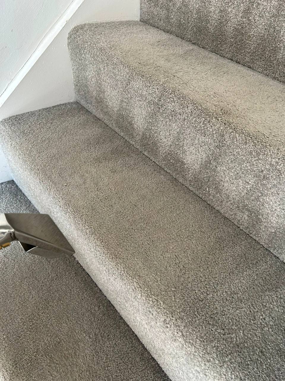 Carpet extraction cleaning in progress on a staircase